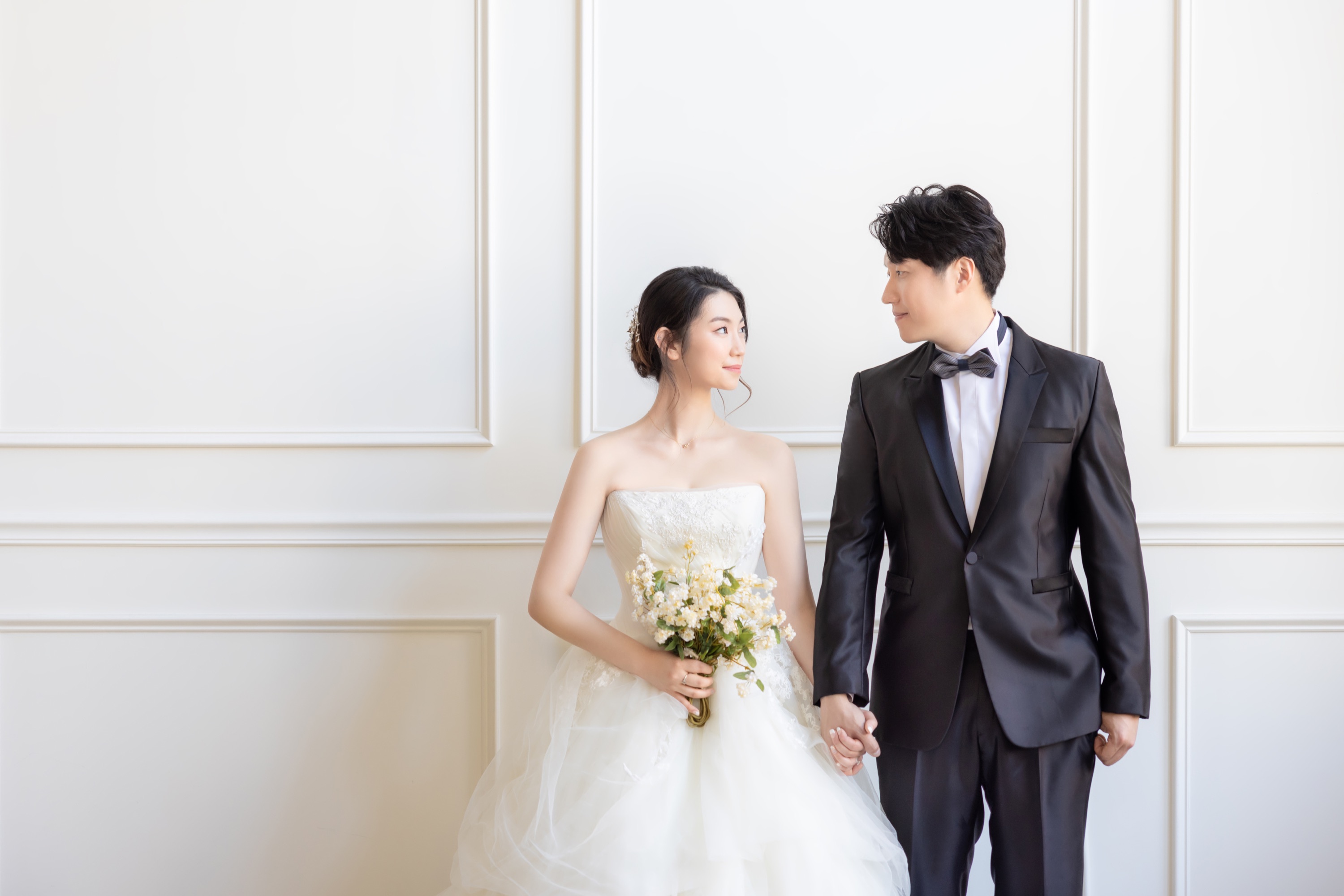 Couple in wedding clothing in a bright studio