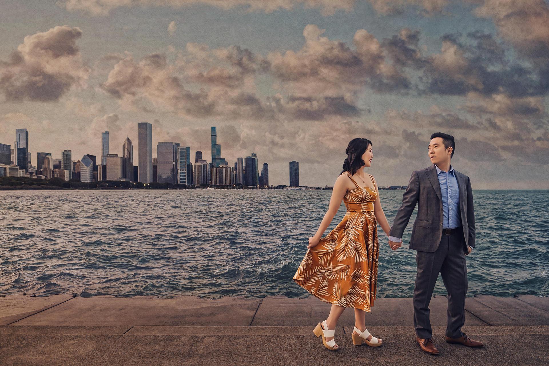 Couple holding hands beside the Chicago lakefront