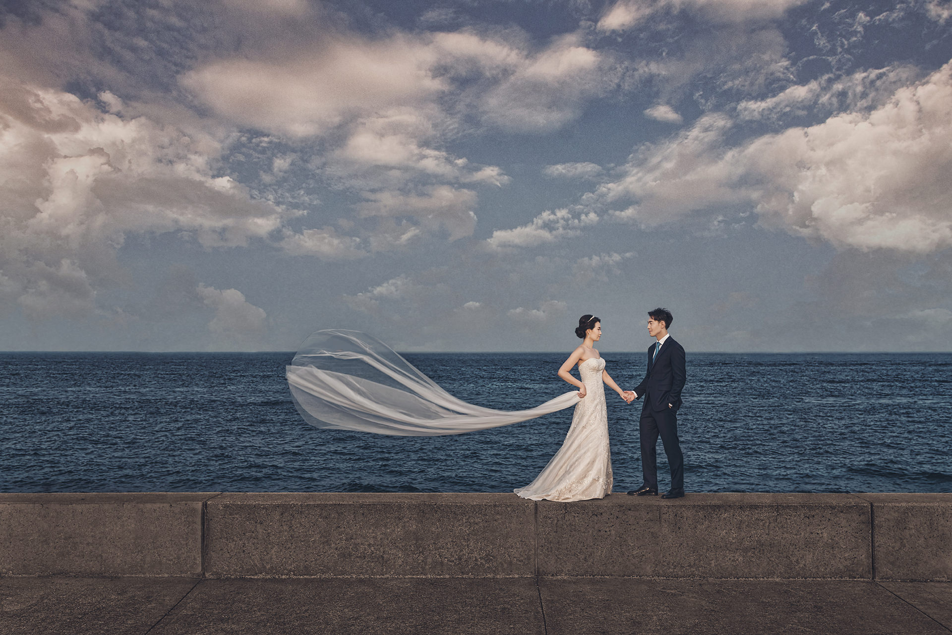Couple in wedding attire by the Chicago lakefront