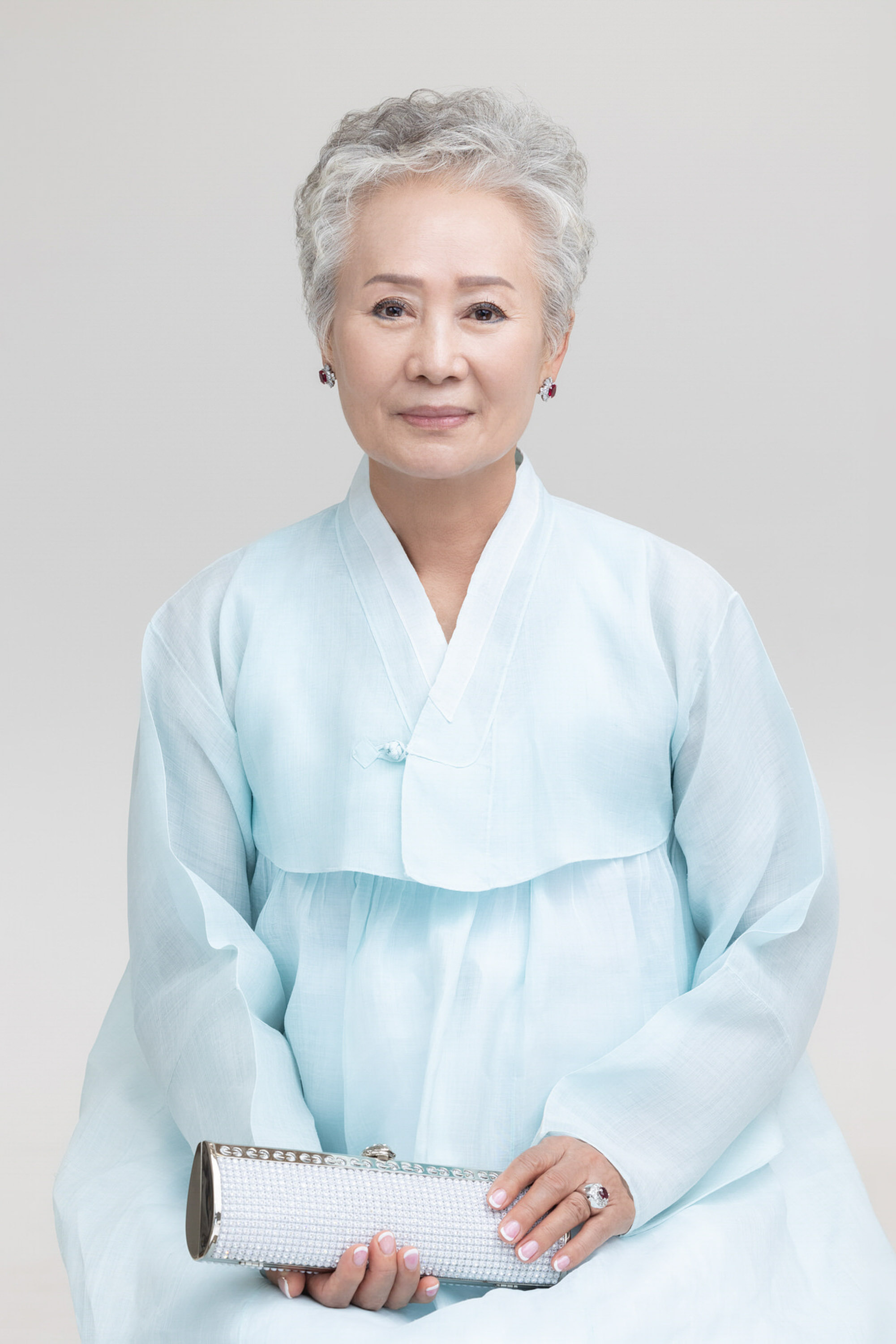 Older woman wearing pale blue hanbok for an individual portrait